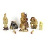 A group of Chinese soapstone carved figures to include one carved with monkeys, 18.5cm high together