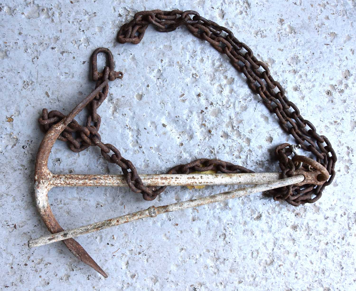 A antique cast iron anchor and chain.