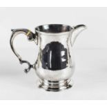 An early George III silver jug, of baluster form, the auricula handle with curled acanthus scroll
