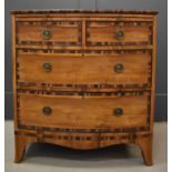 A 19th century bow front chest of drawers, cross banded in coromandel, comprising two short over two