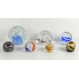 A Selkirk glass paperweight together with others of different size and form. (7)