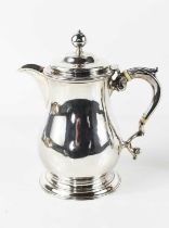 A George II silver coffee pot of baluster form, the auricula handle with acanthus scroll thumb rest,