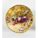 A Royal Worcester plate by Horice Price, painted with peaches and raspberries to a mossy ground,