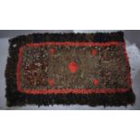 A Crimean War rag rug, made with pieces of uniform. [Trench art made on the front by members of