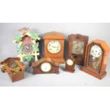 A group of vintage clocks to include two cuckoo clocks and various oak and mahogany cased examples.