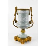 A 19th century French Pâte-sur-pâte and ormolu twin handled urn, pale green with white overlay,