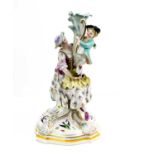 A late 19th century Meissen porcelain figure group of mother and child, standing on her lap