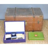 A vintage leather bound steamer trunk together with a vintage first aid tin and some jewellery