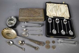 A group of silver items including a set of teaspoons, boxed, silver sugar nips, coins, together with