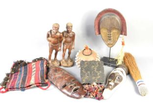 A group of African tribal items to include face masks, hardwood carved figures, wooden ink block and