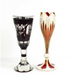 A cranberry glass goblet, likely Austrian, with cameo decoration, the red glass cut back to clear