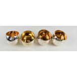 Chris Knight: a set of four silver tumblers with gilded interiors, and weighted balls to the