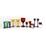 A group of coloured bohemian glassware, to include pair of green and gilded bud vases, red painted