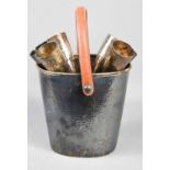 A silver plated repousse champagne set, comprising ice bucket with leather handle and six