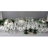 A large group of crystal glass ware and other glasses to include green spiral stem wine glasses.