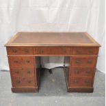 Mahogany kneehole desk with a later skiver above a central drawer flanked with four small drawers to