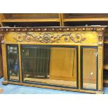 19th century gilt wood mirror, with orbed surmounts above a moulded bust, flanked by two stylised