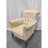 Button back armchair on tapered supports with castors. 82cm high