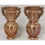 Pair of Hispano Moresque pink lustre vases of twin handled baluster form decorated in typical