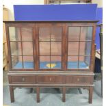 Chippendale style mahogany display cabinet with three glazed doors enclosing glass shelves above