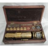 Early 19th century brass cylindrical microscope, unsigned, with various lenses and accessories, in