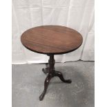 George III mahogany table with a snap action circular top on a turned column and tripod base. 73cm