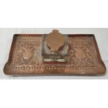 Arts & Crafts copper desk stand, the square glass ink well on rectangular pen tray, with repousse