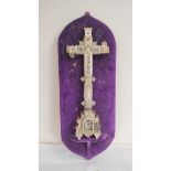 Wood and mother of pearl crucifix with pierced foliate decoration, fixed to a purple velour backing,