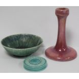 Ruskin Pottery high fired pink lustre candlestick of tapered column form with circular domed foot,