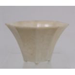 Antique Chinese Dehua Blanc de Chine libation cup of flared octagonal form on four small peg feet