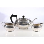 George V silver three-piece tea set, the teapot with presentation inscription 'Presented to the Rev.