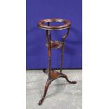 19th century mahogany wig stand with circular recess above a saucer shelf on spiral columns and