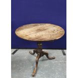 George III oak supper table, with a snap action  circular tilt top, on a turned column and tripod