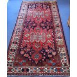 20th century Caucasian carpet in predominantly blue, red and white wools on cotton, with two