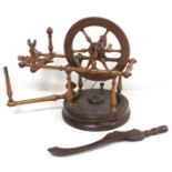 Early 19th century treen bobbin winder with spoked wheel on circular plinth base, 25cm high; also