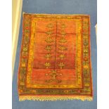 Turkish wool rug with central panel decorated with diamond lozenges in a field of red, yellow and