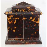 19th century tortoiseshell veneered table top cabinet of rectangular form, the domed top with hinged
