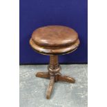 Rosewood and mahogany revolving piano stool;, circa late 19th century, with a brown hide stuffover