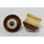 Turned ivory and coquilla nut box of cylindrical form containing a model of an eyeball with