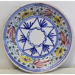 19th century Continental tin glazed Delft circular charger with polychrome floral and geometric