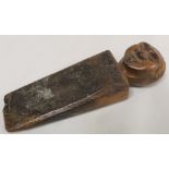 Antique treen oak doorstop of wedge form with finial in the form of a man's head, 26cm long.