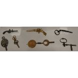 Gold watch key with perpetual calendar and seven cut steel and other watch crank keys.