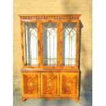 Reproduction mahogany display cabinet with three astragal glazed doors above a lower cupboard