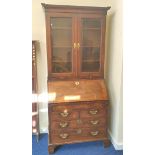 Mid 18th century red walnut bureau bookcase with  glazed doors above a fall-front enclosing fitted