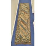 Turkish wool runner with geometric field and borders in blue, brown and cream, 324cm x 82cm.