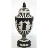 20th century Wedgwood black dip jasperware "Dancing hours" covered vase of urn form with acorn