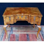 Early 20th century Queen Anne-style walnut desk with a shaped top above a single drawer flanked by
