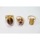 18ct gold garnet ring, '750', another with tiger's eye and a ring with arched faceted beads, 12g