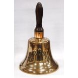 Brass ship's bell, impressed 'Bedouin', with a wooden handle, 33cm high. HMS Bedouin was a Tribal-