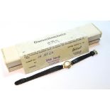 Lady's Buttes Watch Co., 14k gold watch, on strap, 1964, with guarantee.